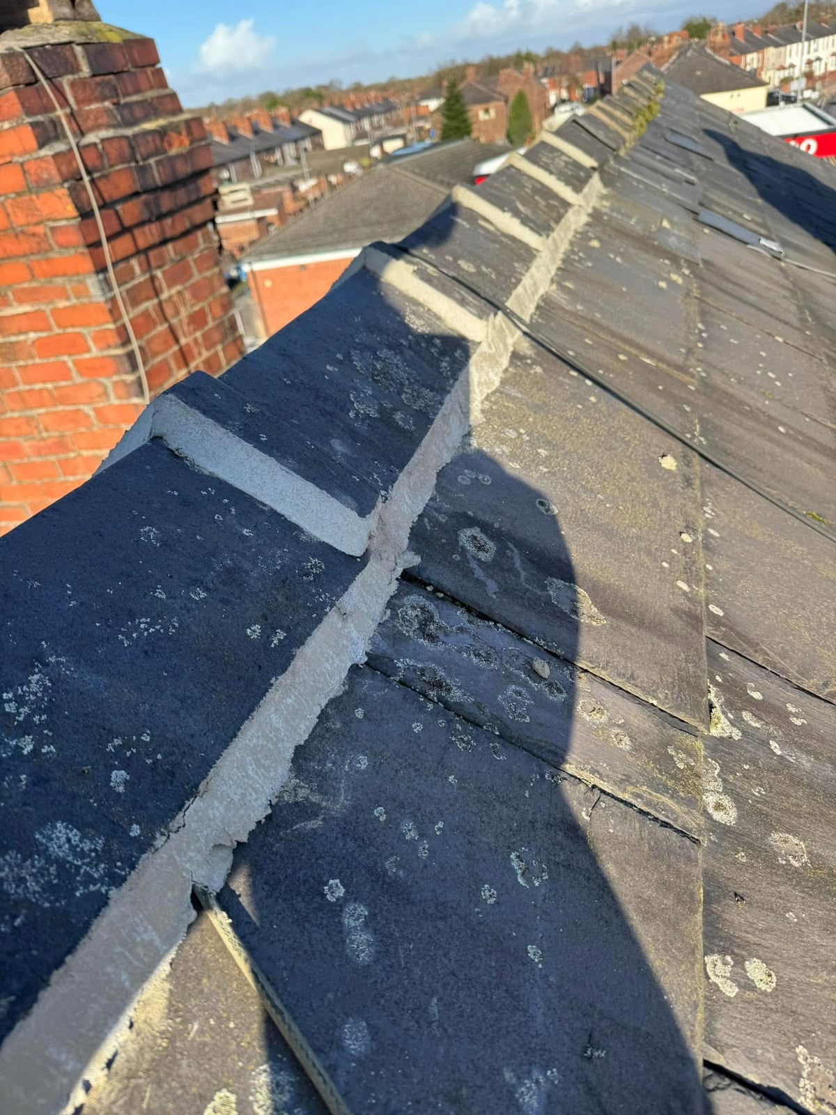 Roof repairs Glasgow: slate roof ridge re-bedded and repointed in fresh mortar