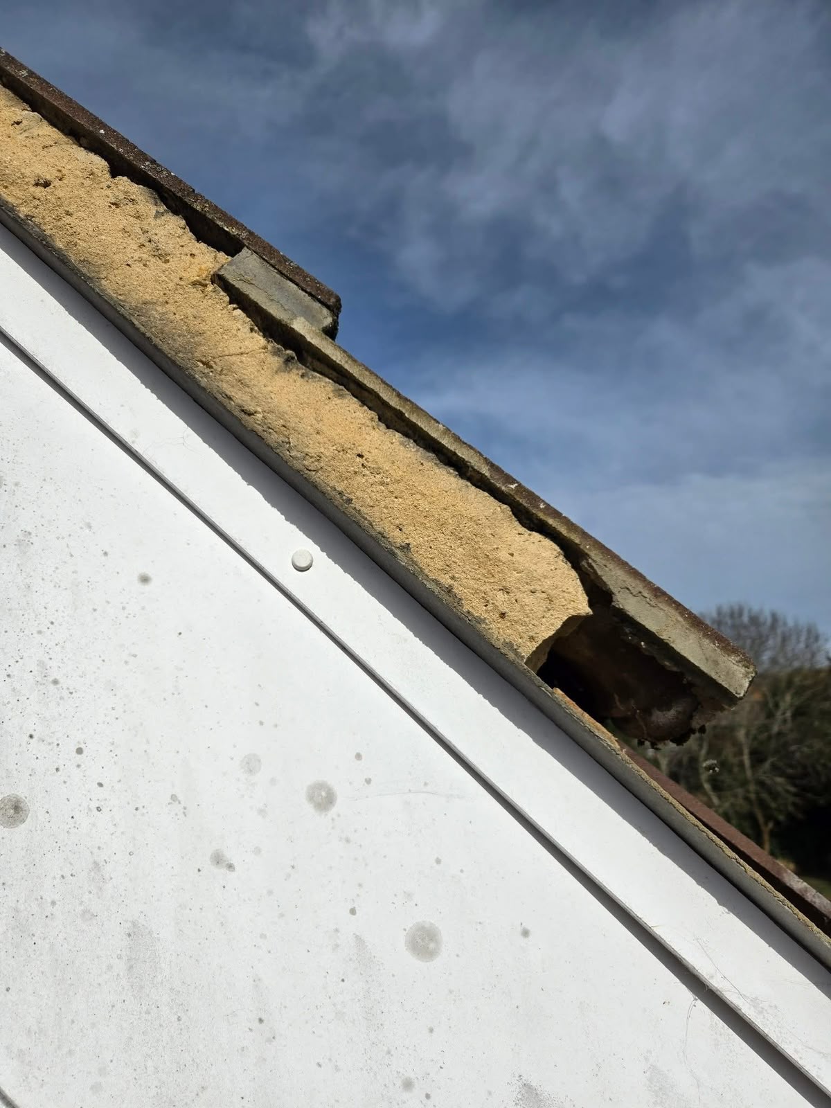 uPVC roofline Glasgow: worn verge mortar exposed above a new bargeboard