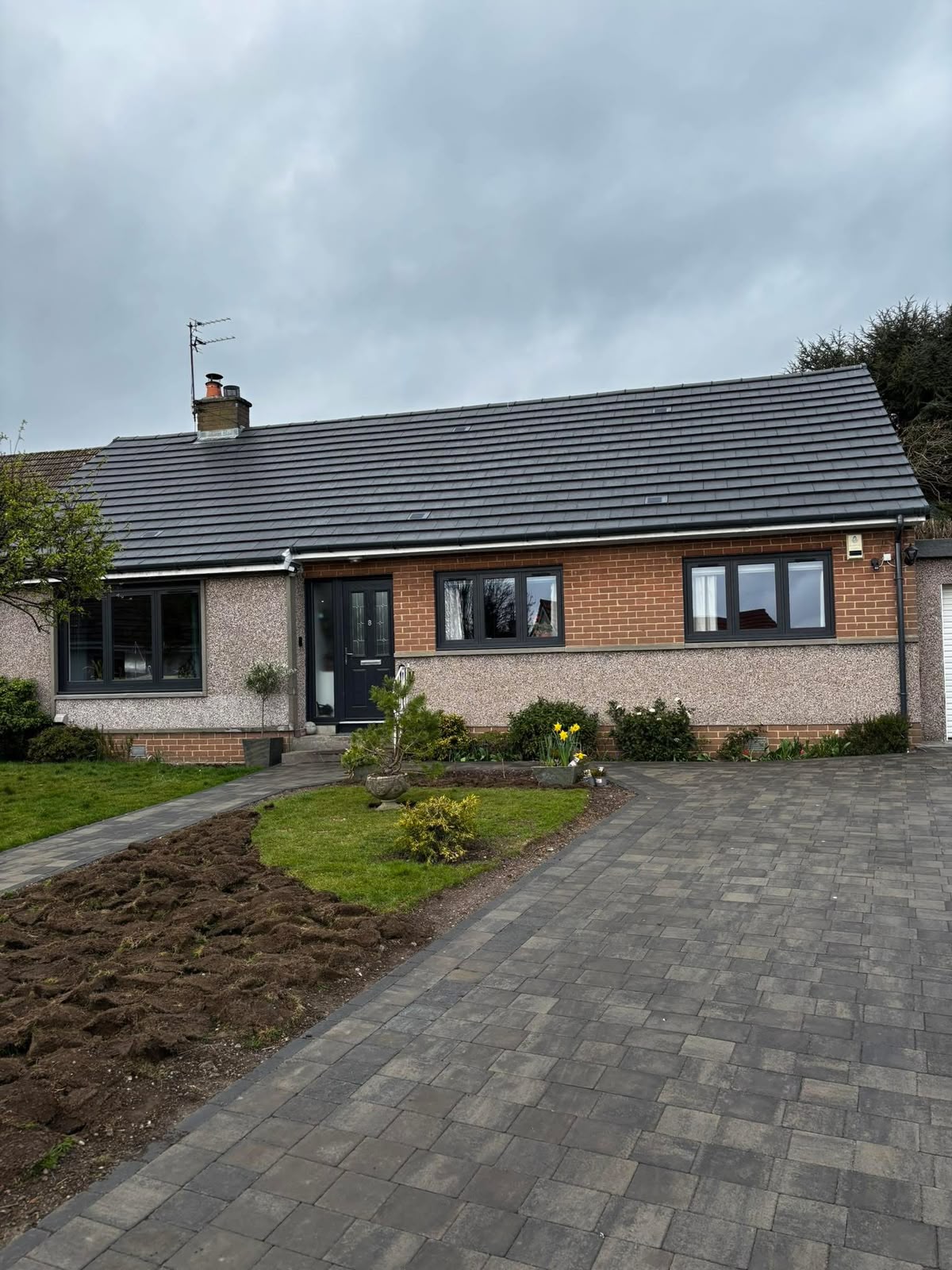 Roof replacement in Glasgow: completed grey tile roof replacement on a bungalow