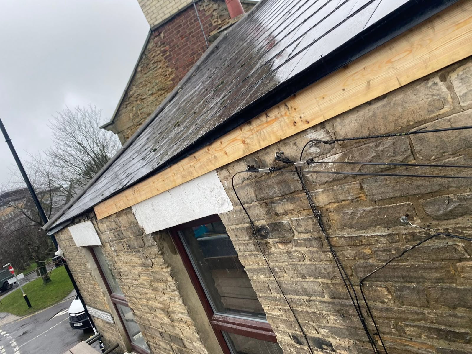 Property maintenance Glasgow: new timber fascia board fitted to a stone building