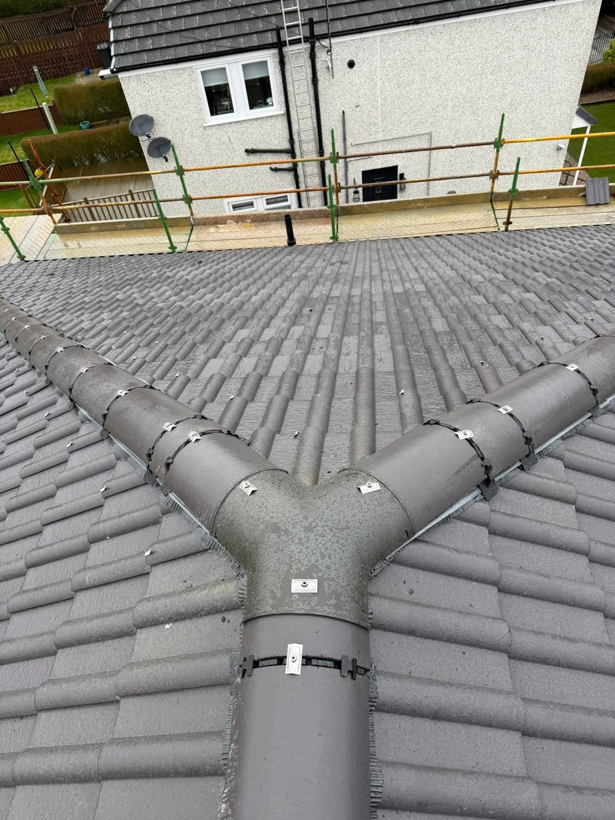 Roofing contractor Glasgow: finished grey tiled roof with a new dry ridge system fitted